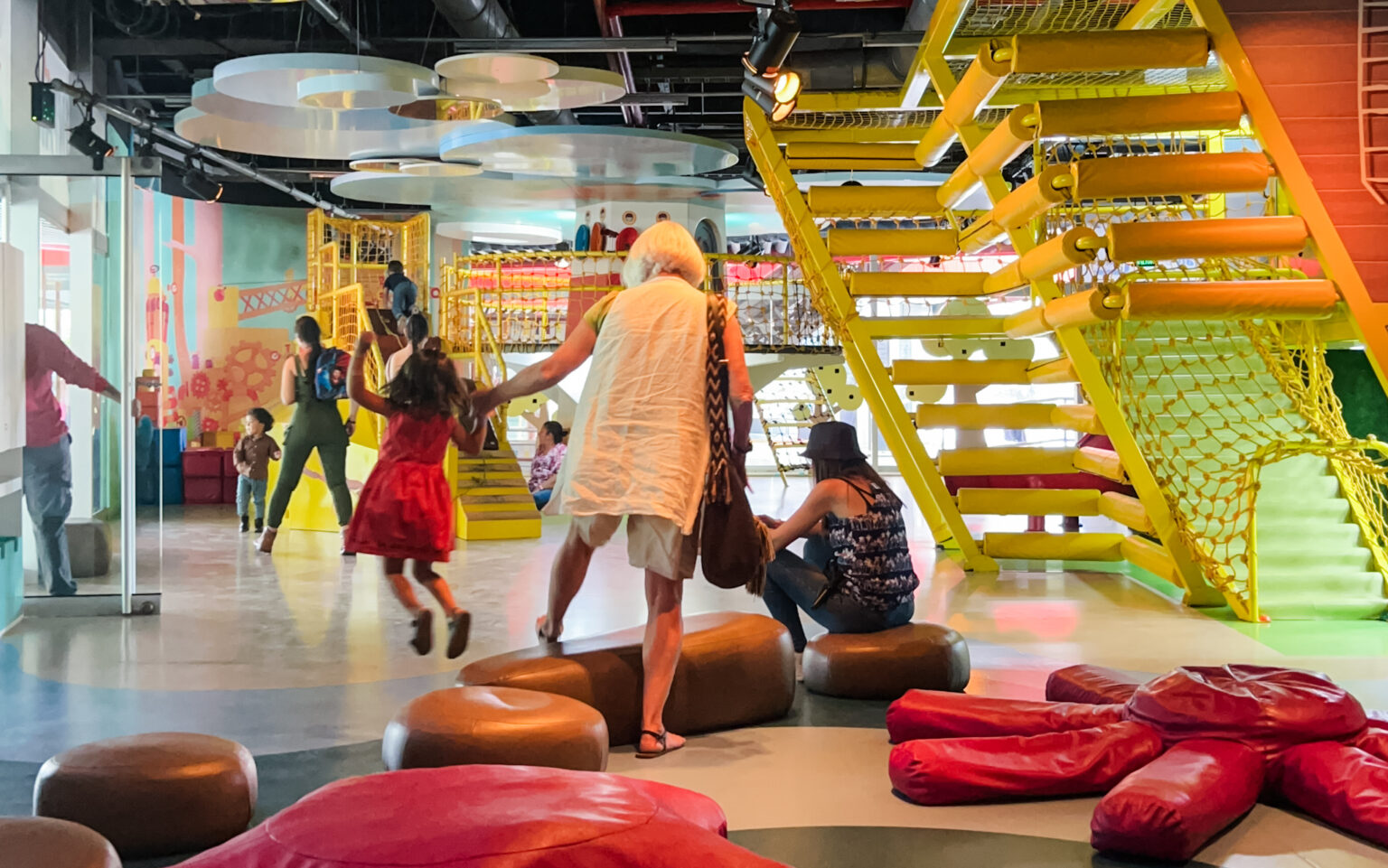 Families exploring an indoor play space in Medellín